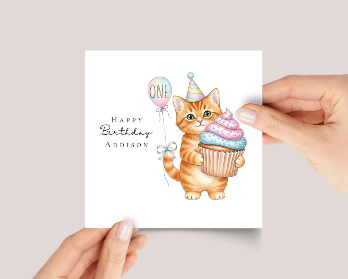 First Birthday Card With Orange Tabby Cat Holding Cupcake - Image 1 First Birthday Card With Orange Tabby Cat Holding Cupcake