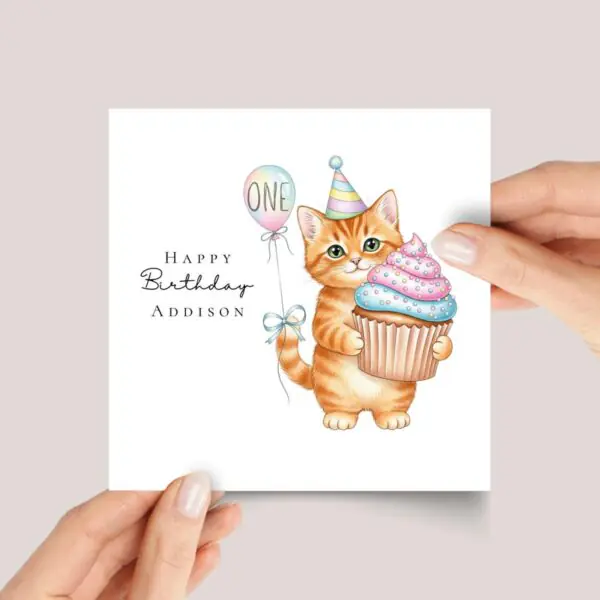 First Birthday Card With Orange Tabby Cat Holding Cupcake